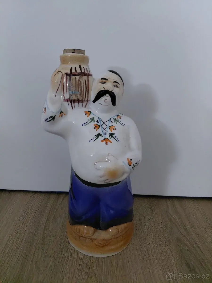Figurální keramická lahev ve tvaru kozáka.